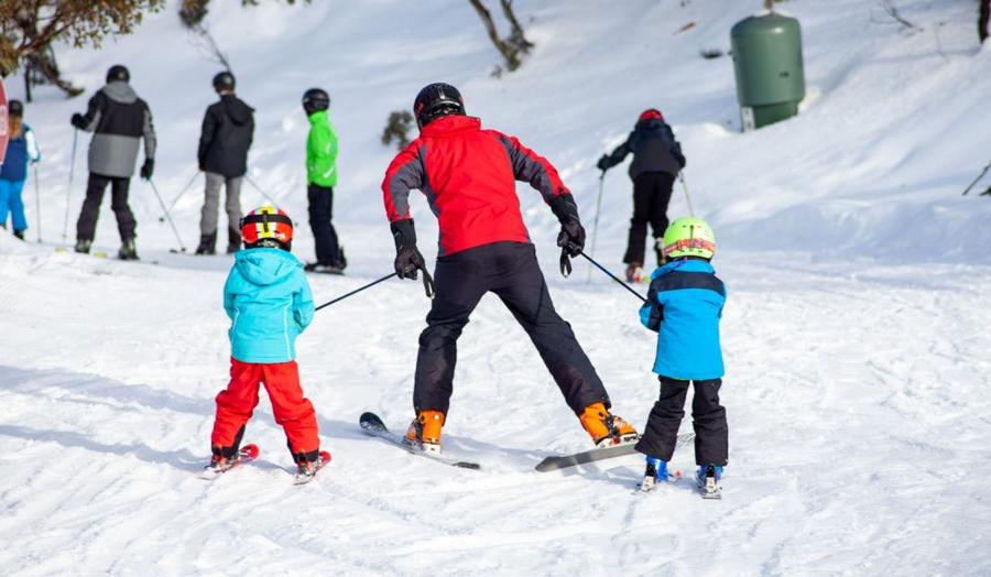 A ski group and children on a practice slope.