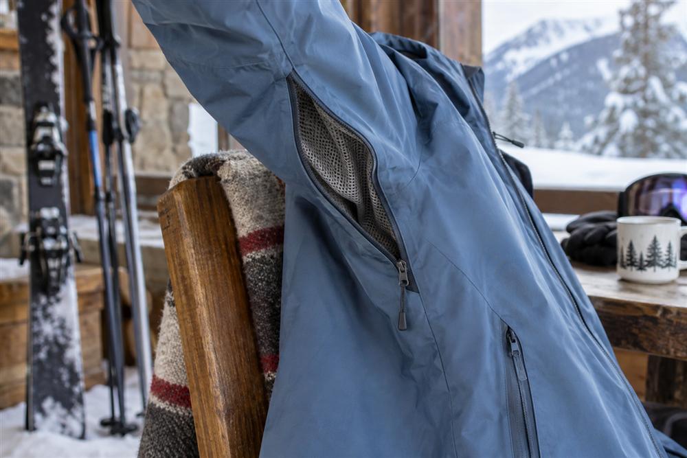 An open underarm ventilation zipper with a mesh panel on a ski jacket