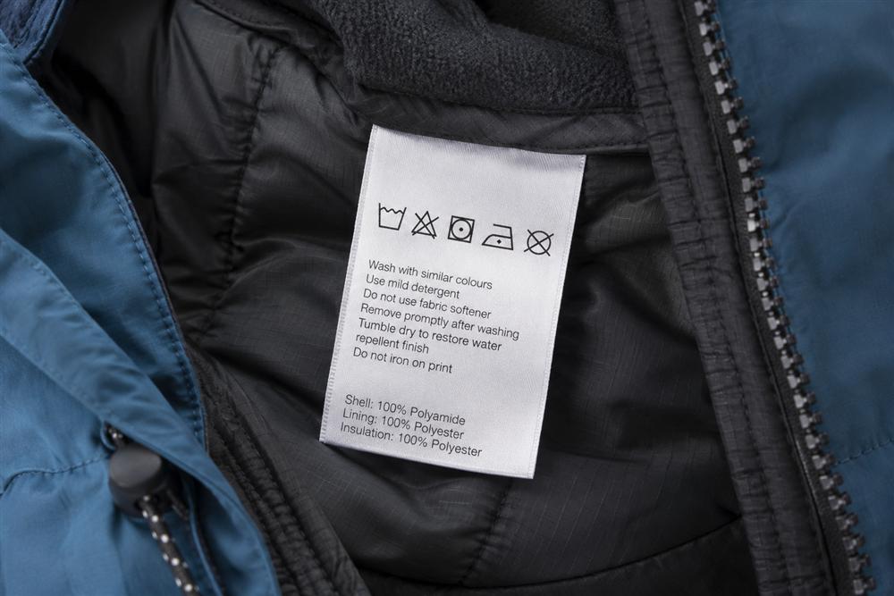 An illustrative garment care label inside a technical ski jacket